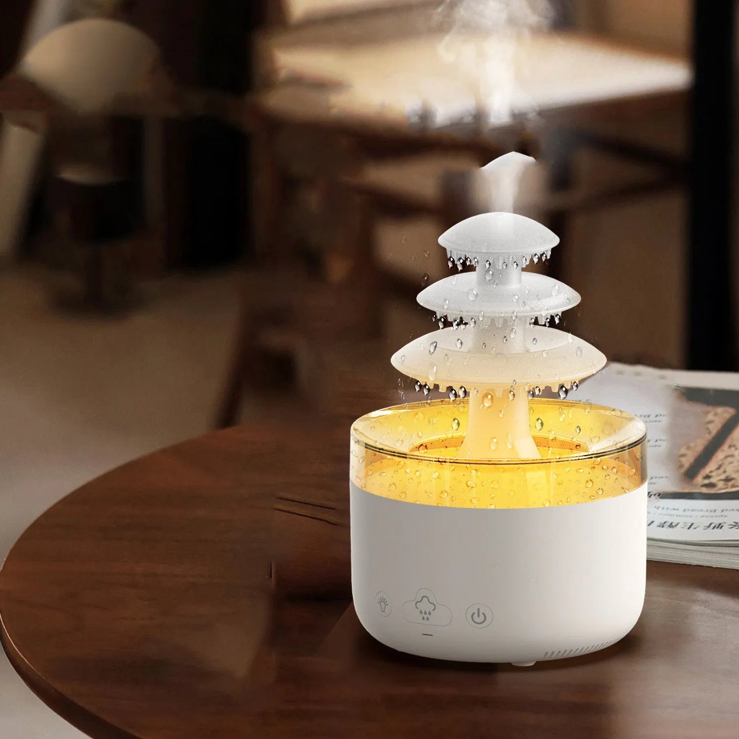 White cloud-shaped USB humidifier and essential oil diffuser with LED lights on a table