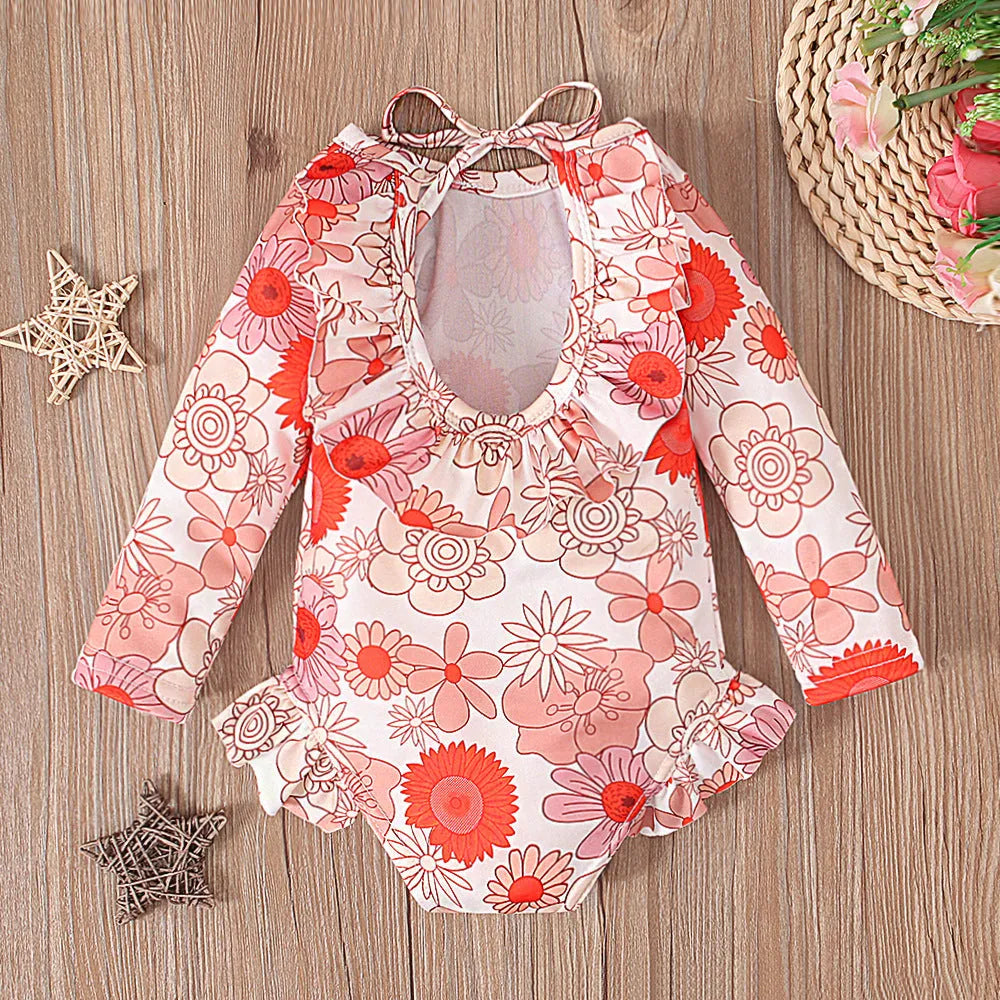 Girls floral print swimsuit with crew neck front and open back in orange colour