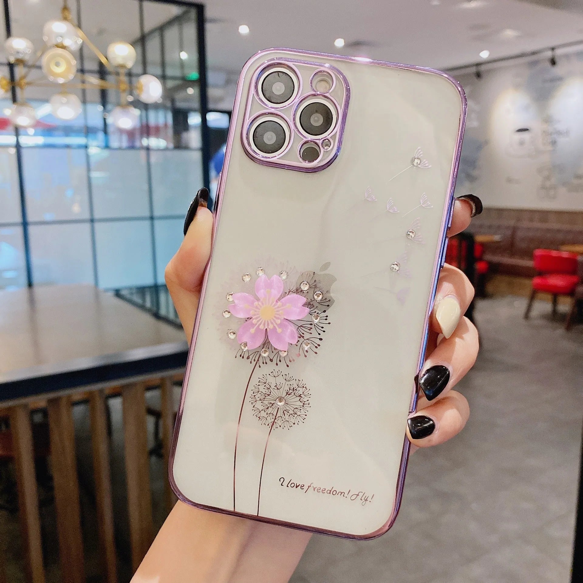Green iPhone case with a built-in 3D white flower stand popped out, showing the phone propped up for viewing.