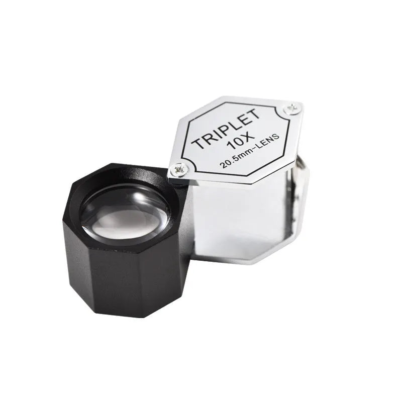 Handheld portable metal magnifying glass with optical glass lens for jewellery and coin identification.