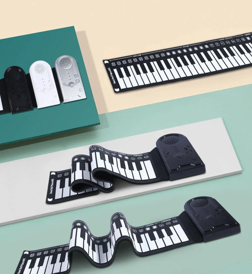 Pearl white portable electronic keyboard with rolled-out silicone keys and compact ABS plastic control panel.