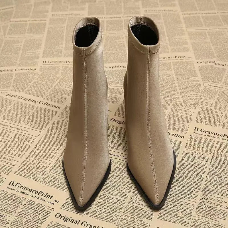 Women's khaki stretch artificial velboa ankle boots with a wedge heel and pointed toe on a plain background.