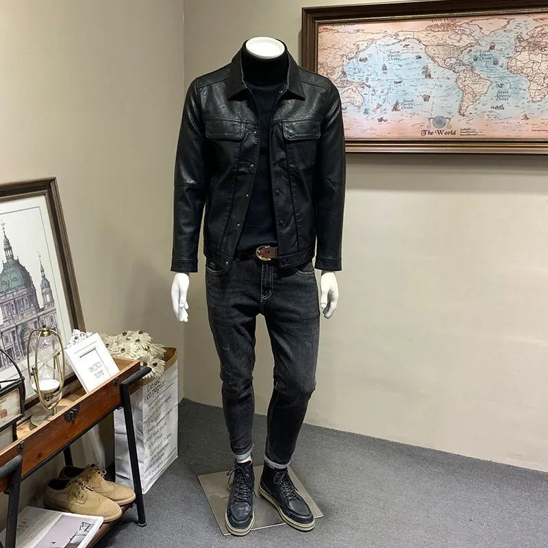 Front view of a black men's artificial leather biker jacket with loose fit, medium length, on a neutral background