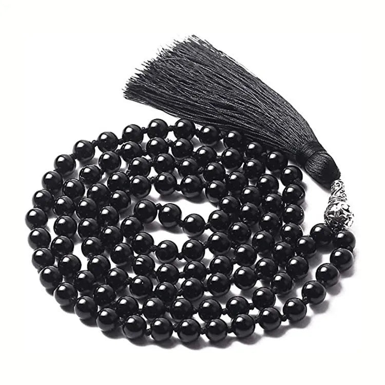 Long geometric agate tassel necklace with multi-coloured stones on a white background.