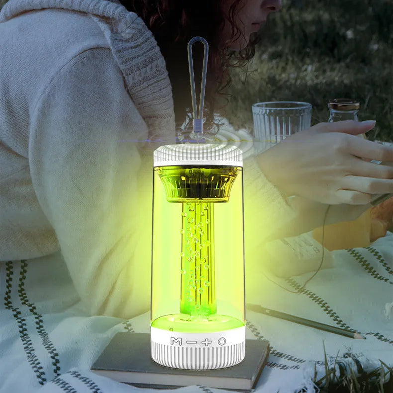 Black outdoor portable camping light Bluetooth speaker with LED colourful light on a natural background
