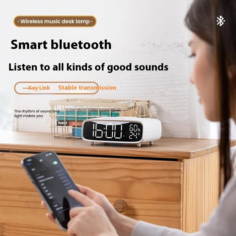 White round Bluetooth speaker wireless charger alarm clock with night light on bedside table