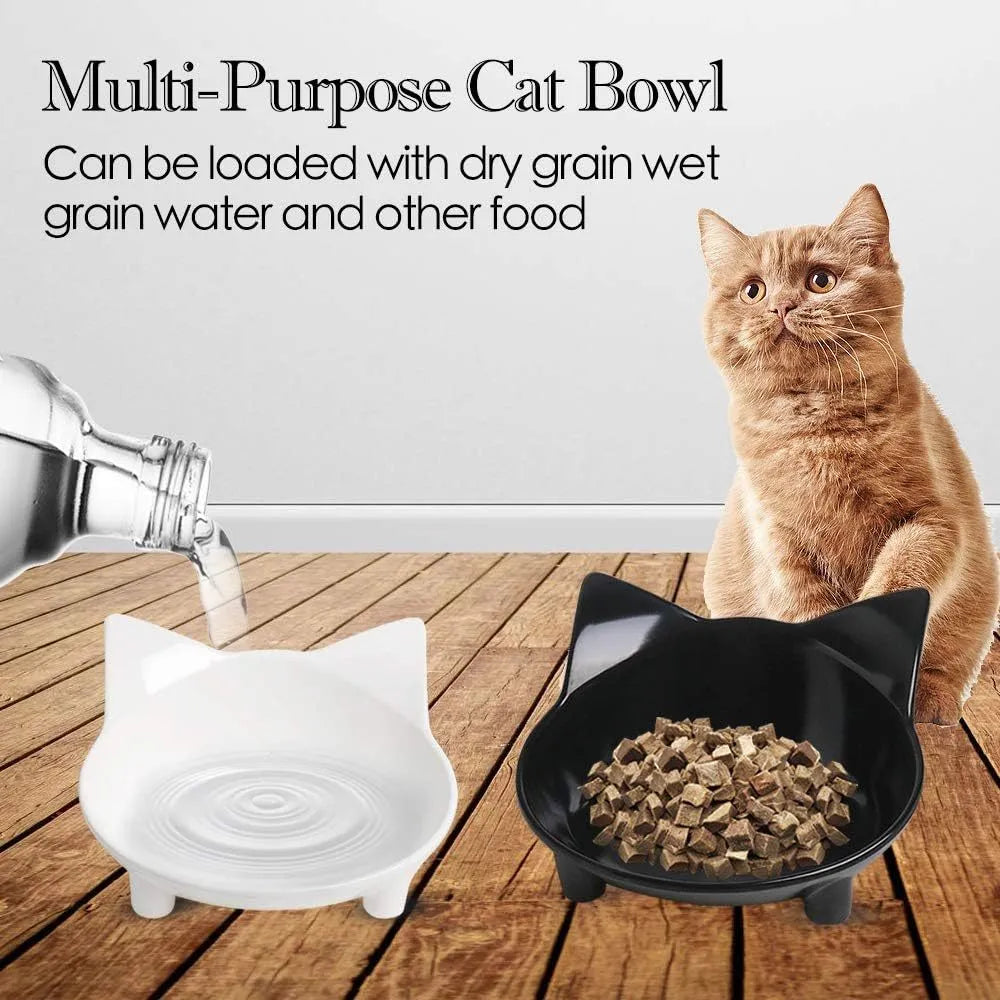 Shallow black and white melamine pet bowls with non-slip rubber bases on a kitchen floor.