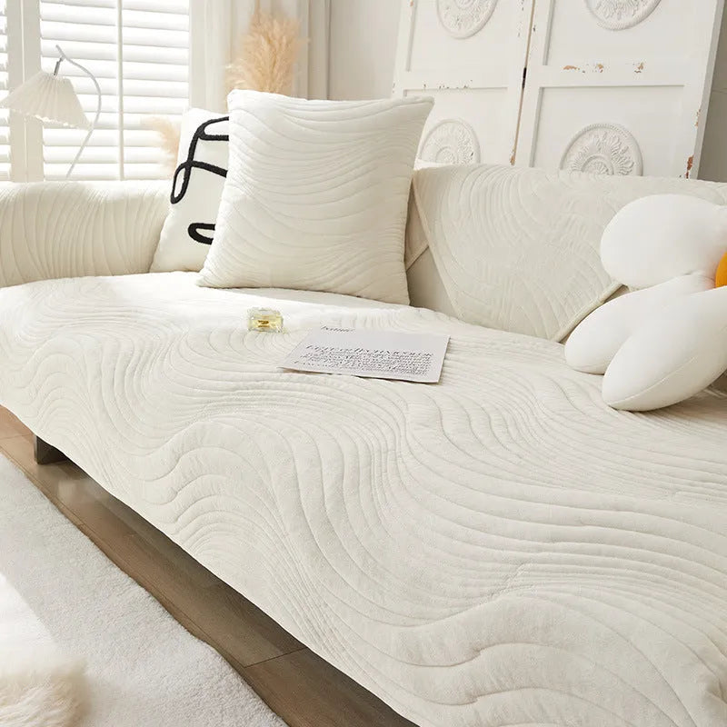 Thickened non-slip flannel sofa cover with geometric pattern in beige on a modern sofa