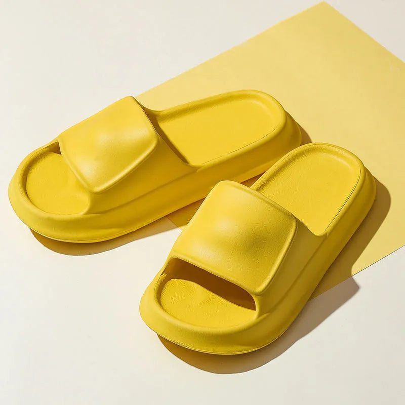 Pair of thick-soled white EVA flip-flop slippers with a non-slip patterned sole.