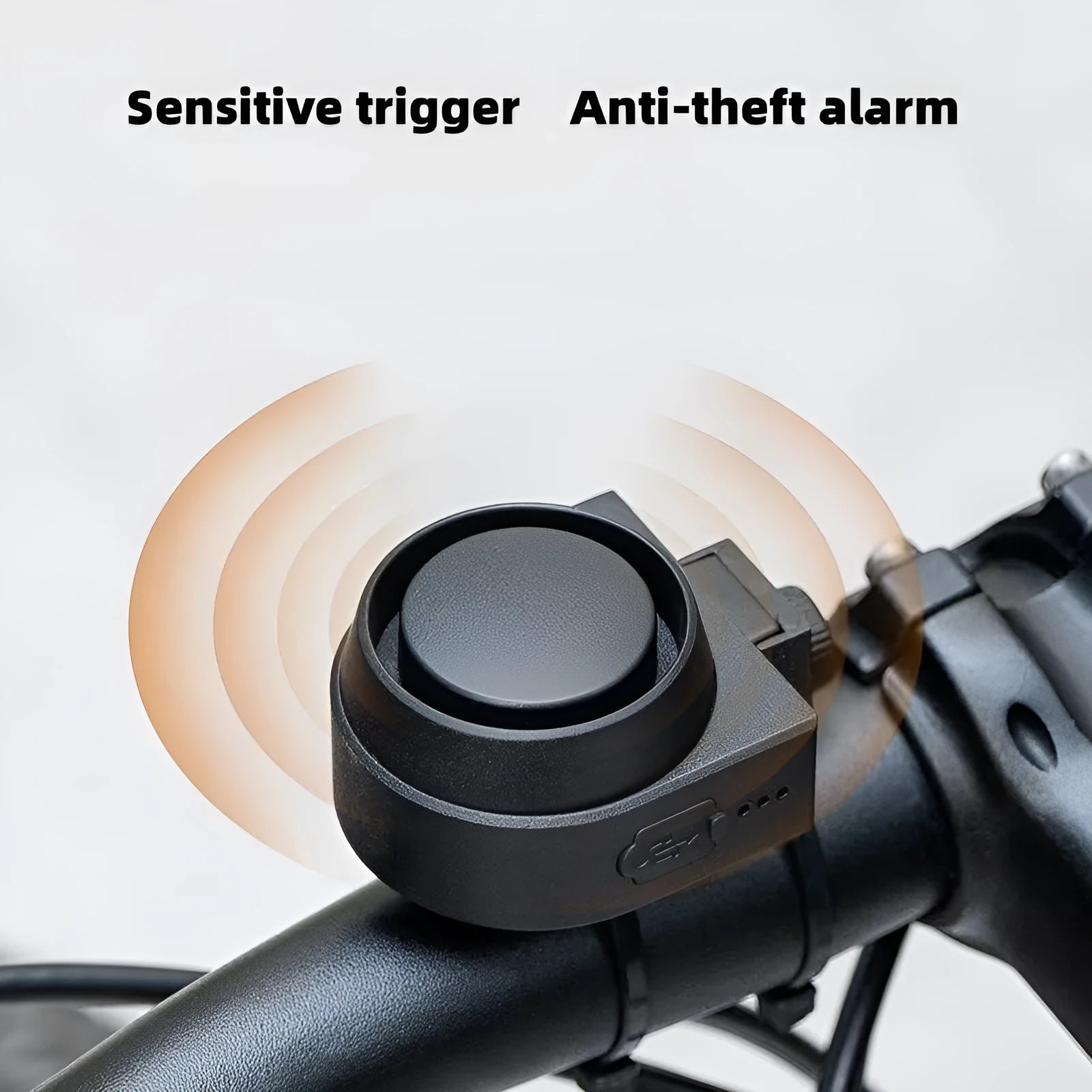 Black ABS rechargeable bicycle and motorcycle alarm with remote control and USB cable, showing compact unit and remote