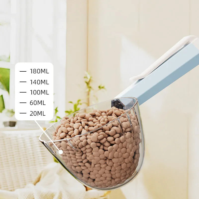 Blue plastic pet food spoon with a white clip attached to a dog food bag.