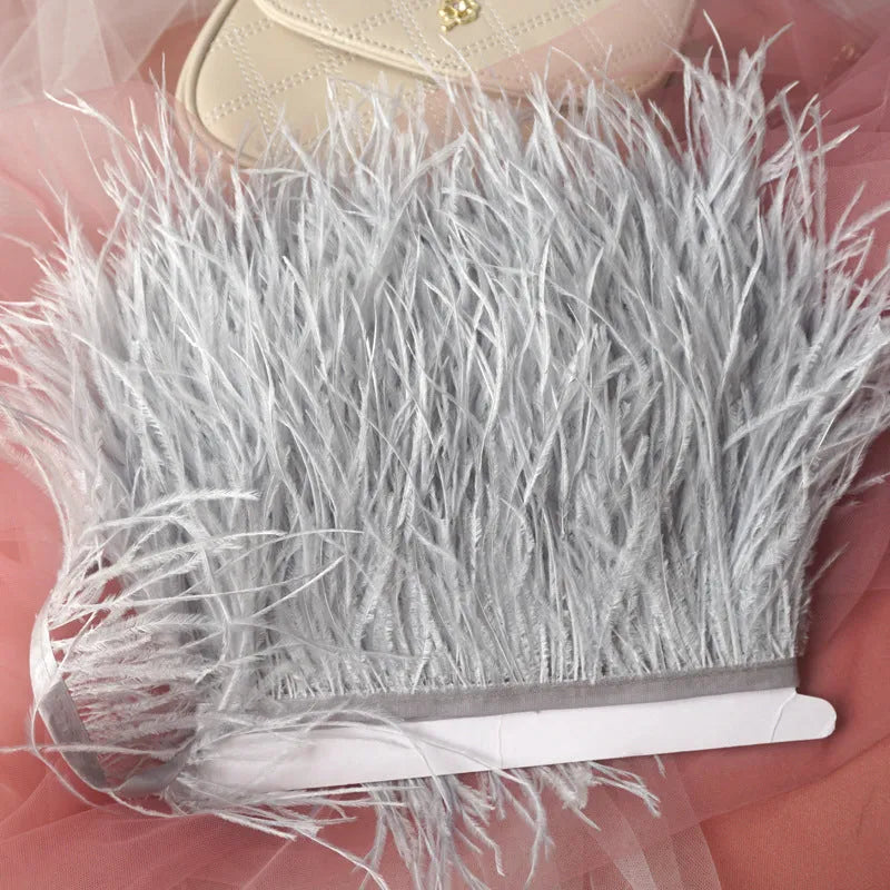 Decorative feather cloth strip in multiple colours including white, black, and mint green for DIY clothing and craft projects