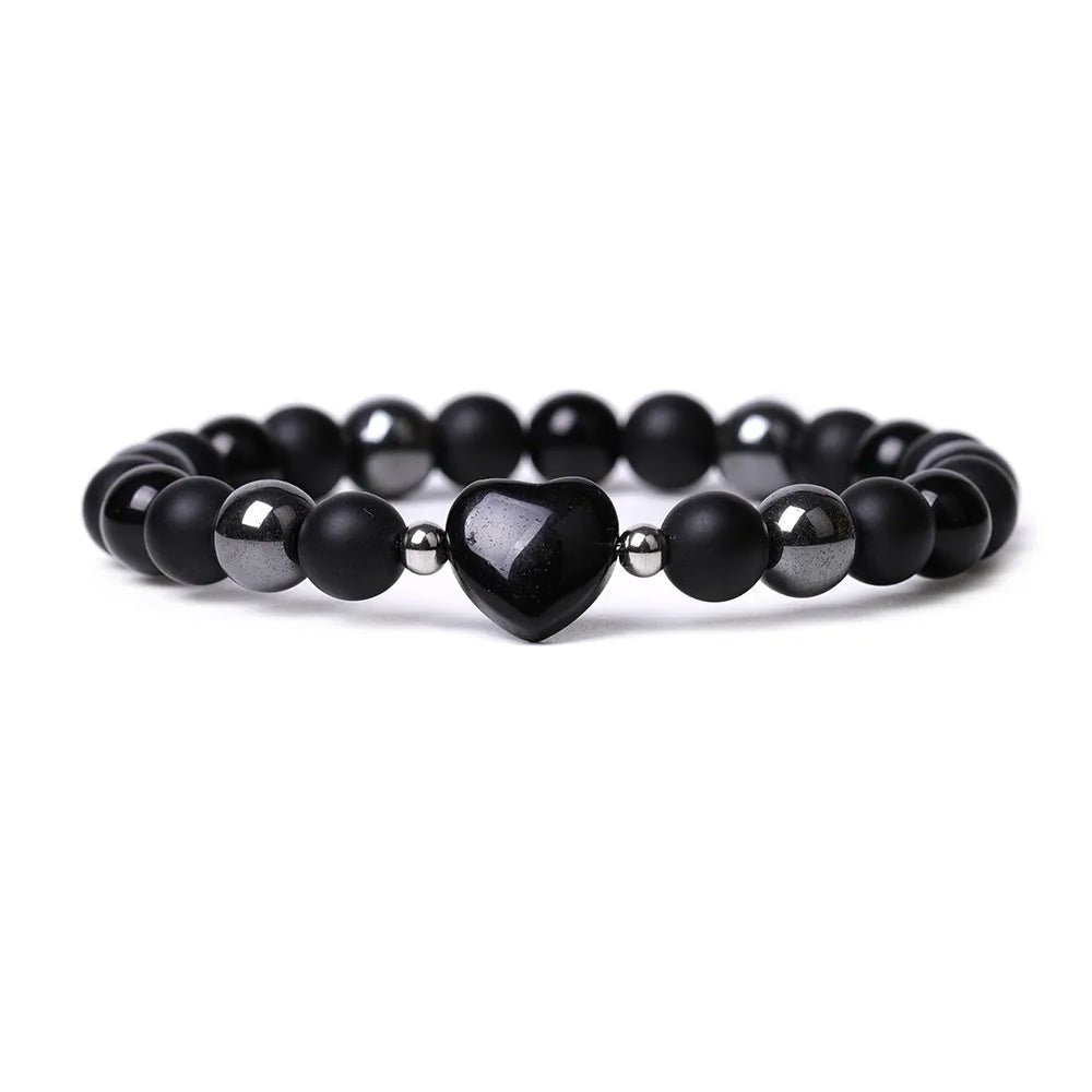 Hand-cut stone peach heart bracelet in Tigereye with geometric design and celestial moon planet motifs
