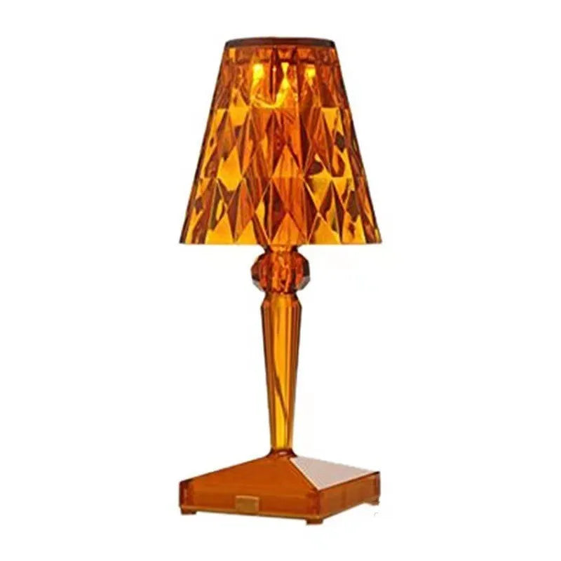 Rose gold plated portable touch night light with acrylic body on a surface.