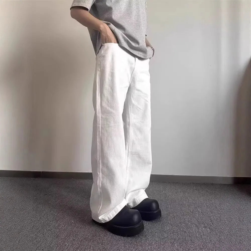 Men's white loose straight-leg wide-leg denim jeans on a mid-waist with a zipper fly.