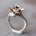 Silver two-tone floral geometric alloy ring for women on a plain background.