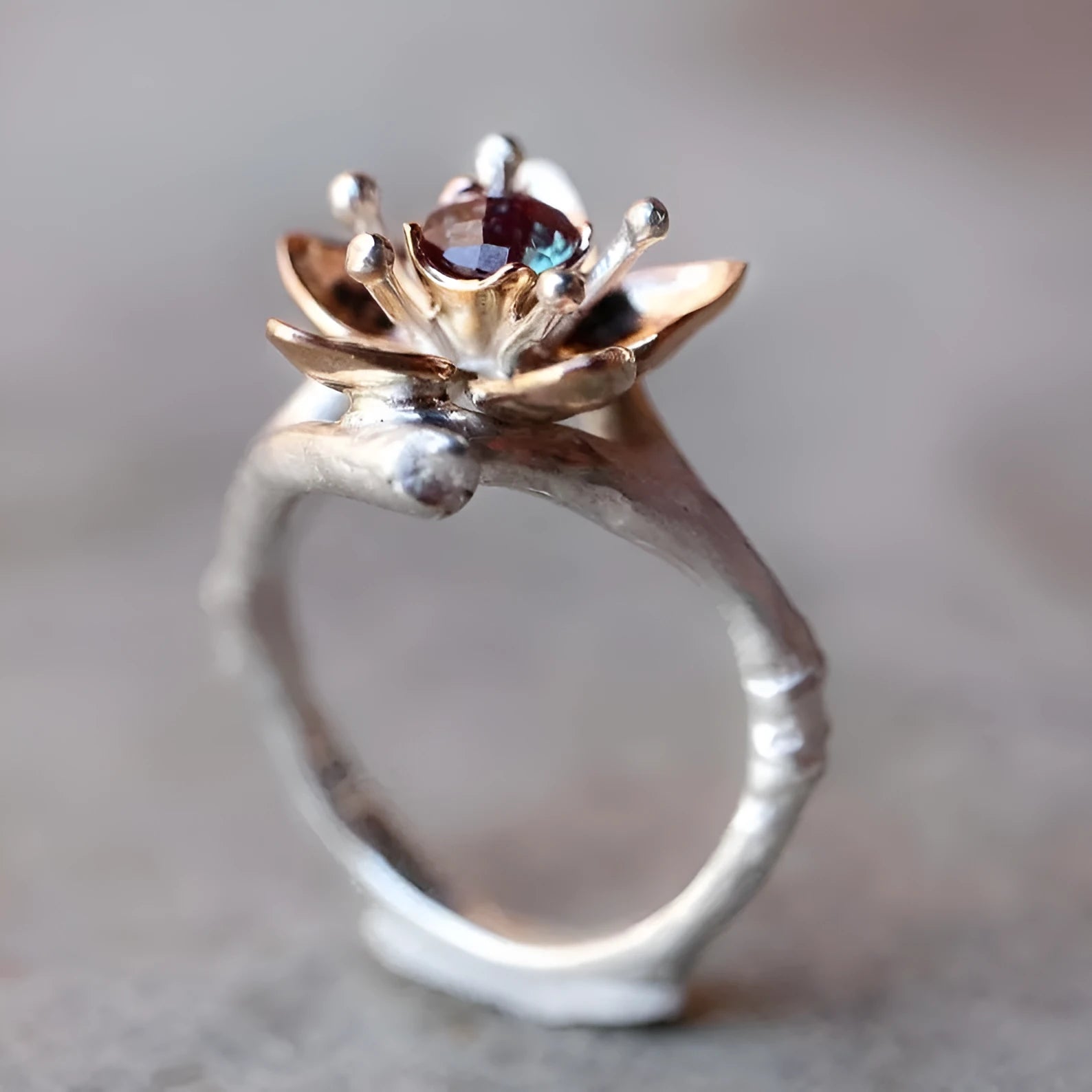 Silver two-tone floral geometric alloy ring for women on a plain background.