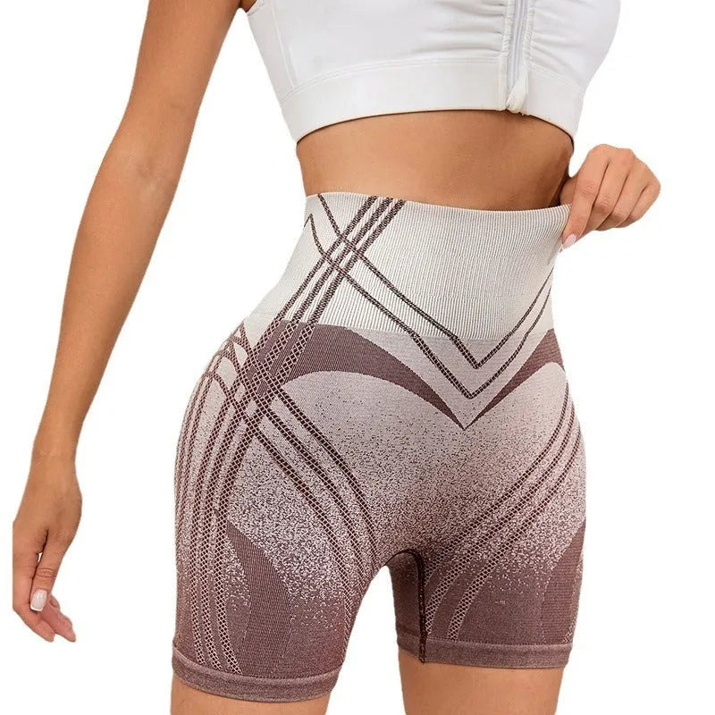 Women's high-waisted gradient fitness shorts in black, shown on a model.
