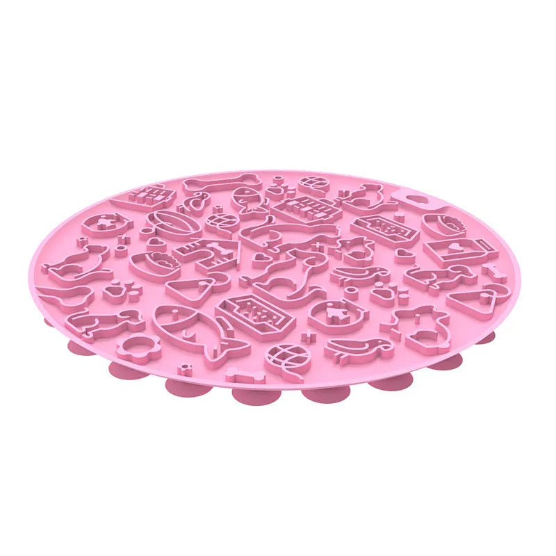 Round silicone pet licking mat in blue colour with suction cup base on a tile floor.