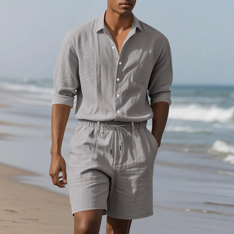 Men's linen beach suit consisting of a long sleeve shirt and shorts, shown in light blue colour.