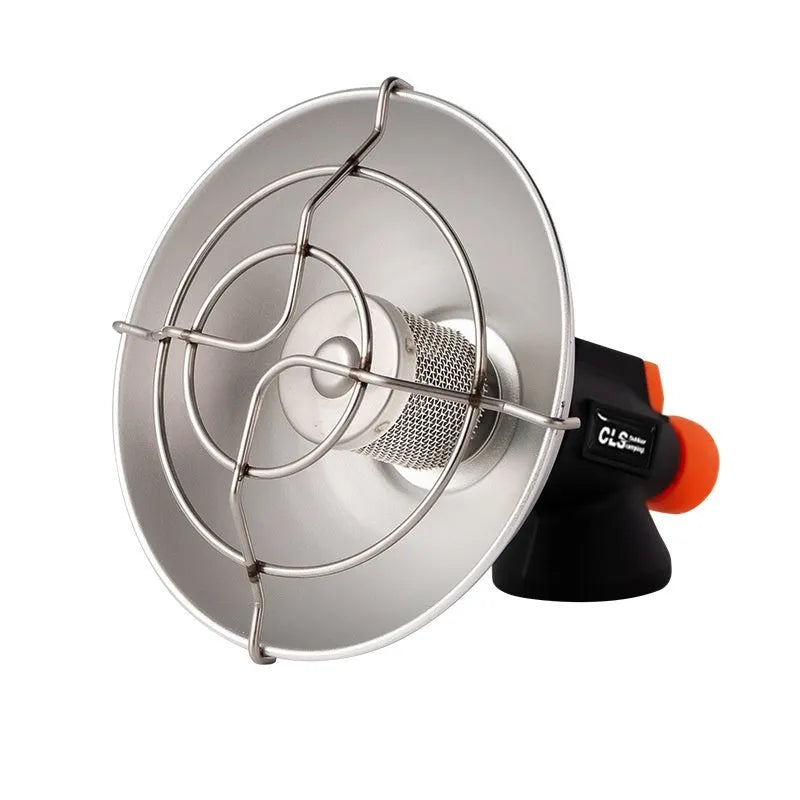 Black and orange portable outdoor heating stove with automatic ignition on a campsite.