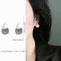 Gold and white drop-shaped geometric ear clip earrings with full diamond detailing and sphere elements