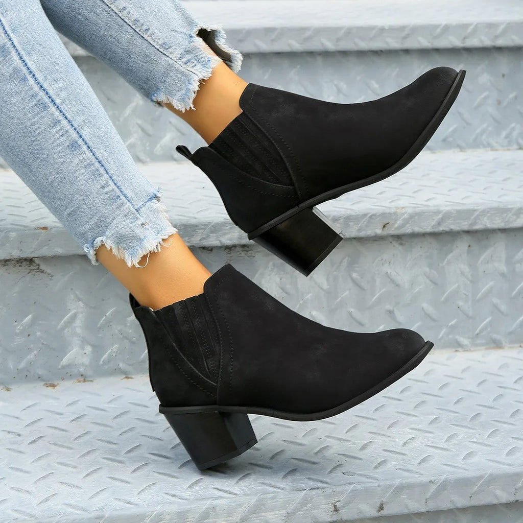 Women's black pointed toe ankle boots with thick square heel slip-on design