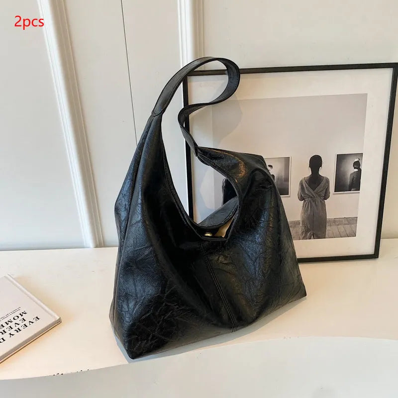 Soft black PU leather women's shoulder bag with large capacity and visible sewing thread detail.