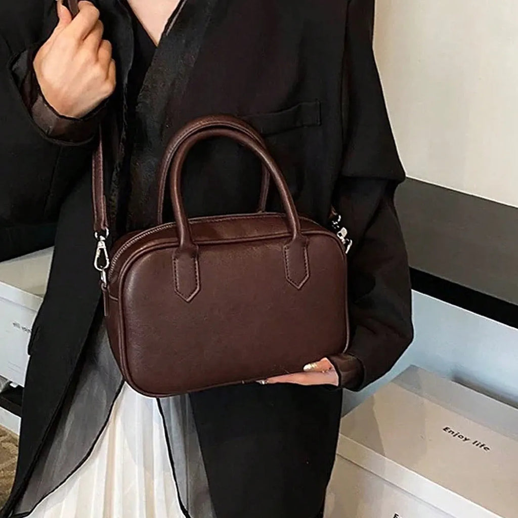 Retro small square PU leather messenger bag in black and coffee brown colours with a single adjustable strap.