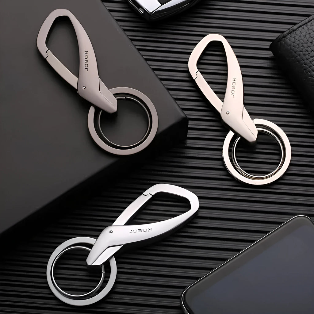 Simple Creative zinc alloy double-ring key chain in black, shown attached to a car key and a belt loop.