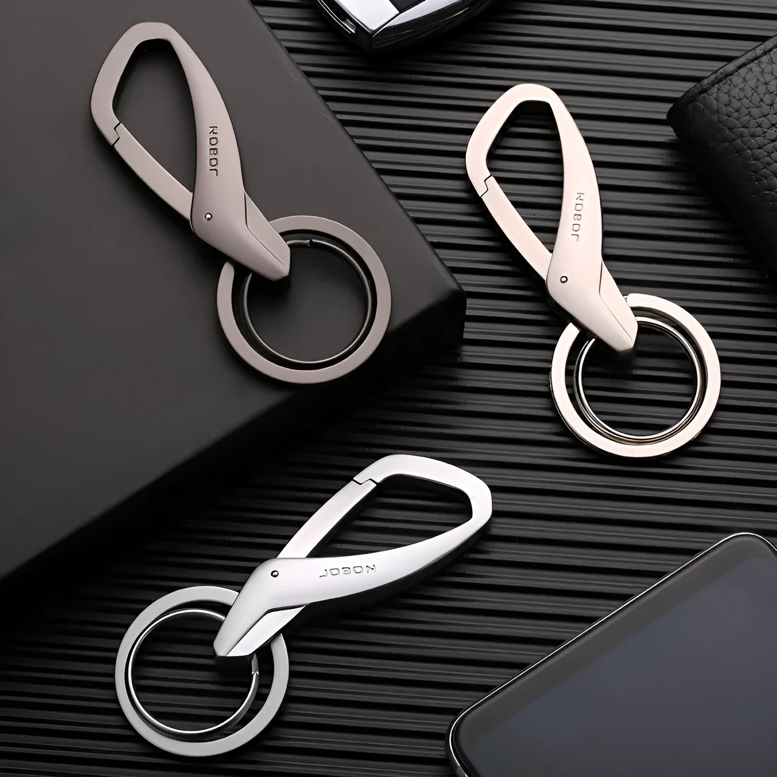 Simple Creative zinc alloy double-ring key chain in black, shown attached to a car key and a belt loop.