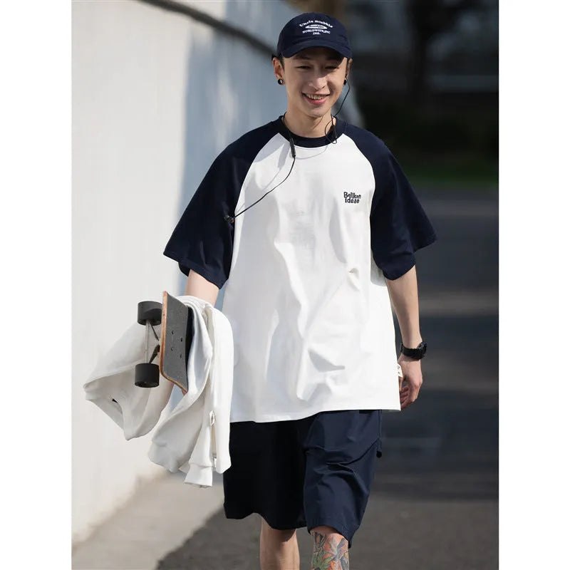 Blue loose-fit men's casual raglan sleeve T-shirt on a hanger