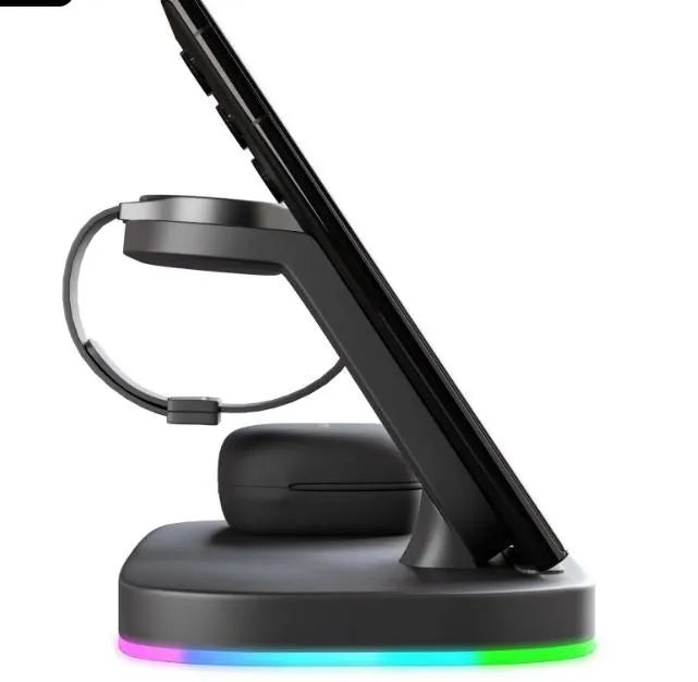 White vertical 3-in-1 wireless charging stand holding a mobile phone, a smartwatch, and wireless earbuds.