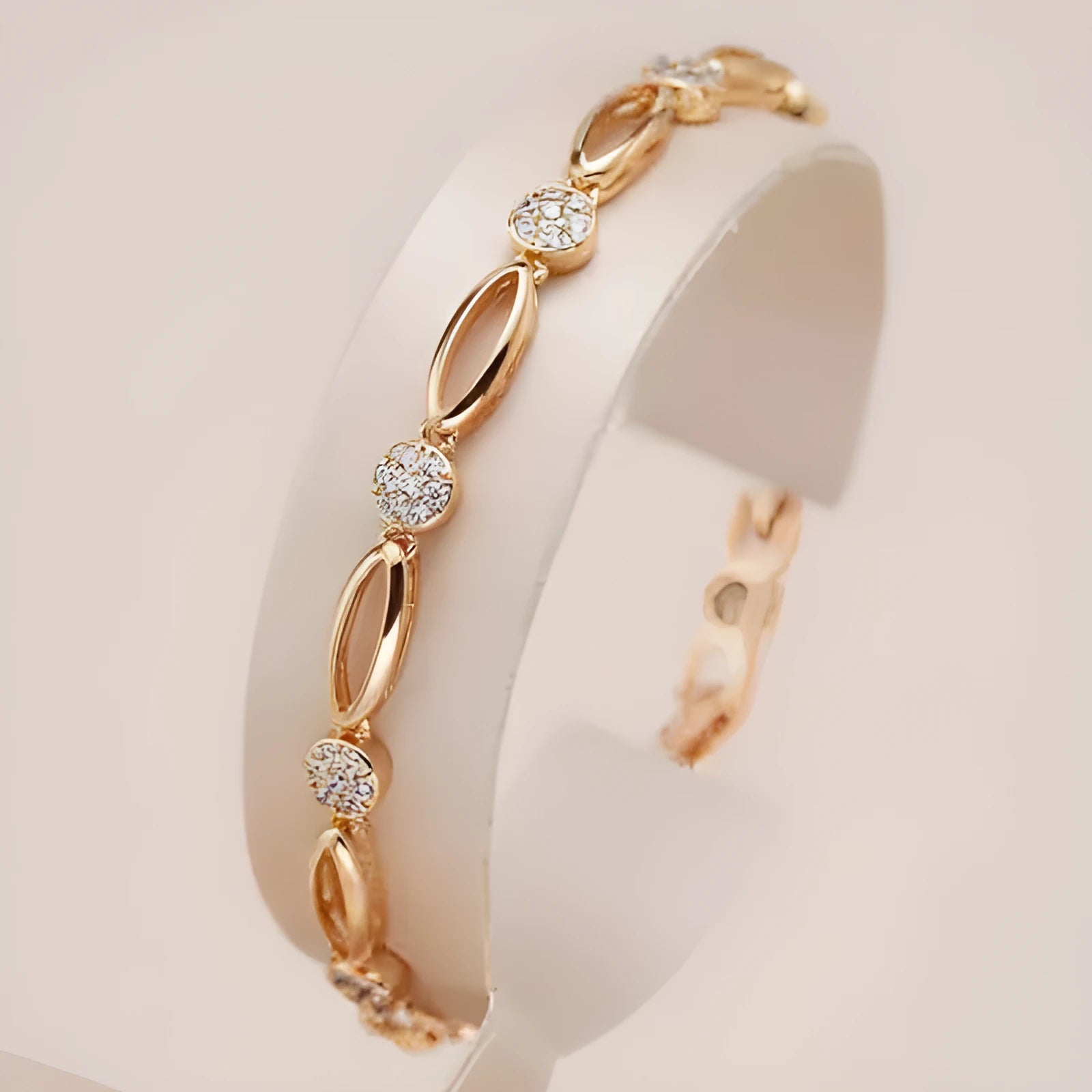 Golden hollow carved copper bracelet with U-shaped design on a wrist.