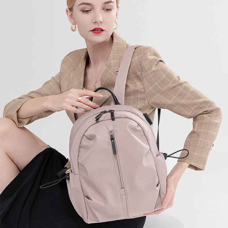 Women's Oxford cloth travel backpack with A4 and 14 inch sizes, multi-pocket interior, and sandwich pocket.
