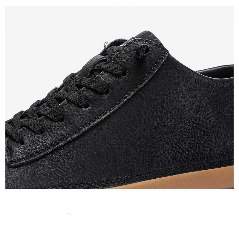 Men's black casual leather shoes with round toe and white rubber sole on a plain background.