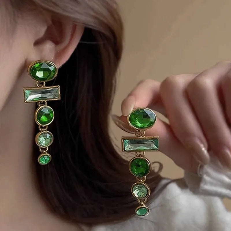 Pair of green gradient geometric alloy earrings with a tassel and inlaid zircon stone details on a white background.