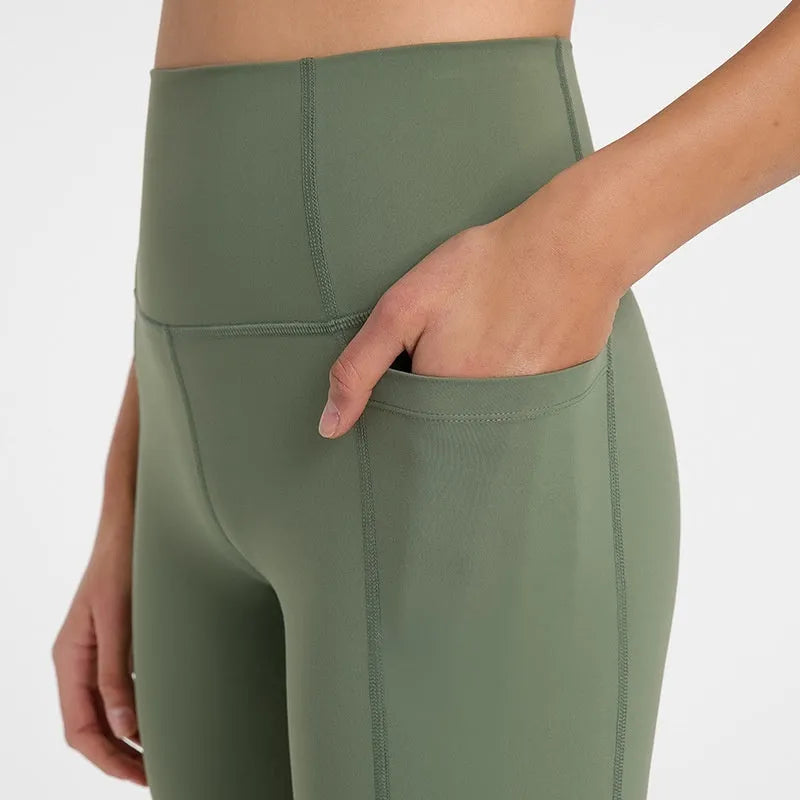 Women's solid colour mid-length sports shorts with a tight fit and waistband.