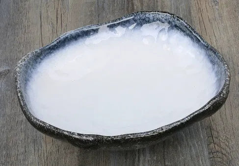 Japanese-style irregular coarse pottery sashimi bowl with floral decoration on glaze
