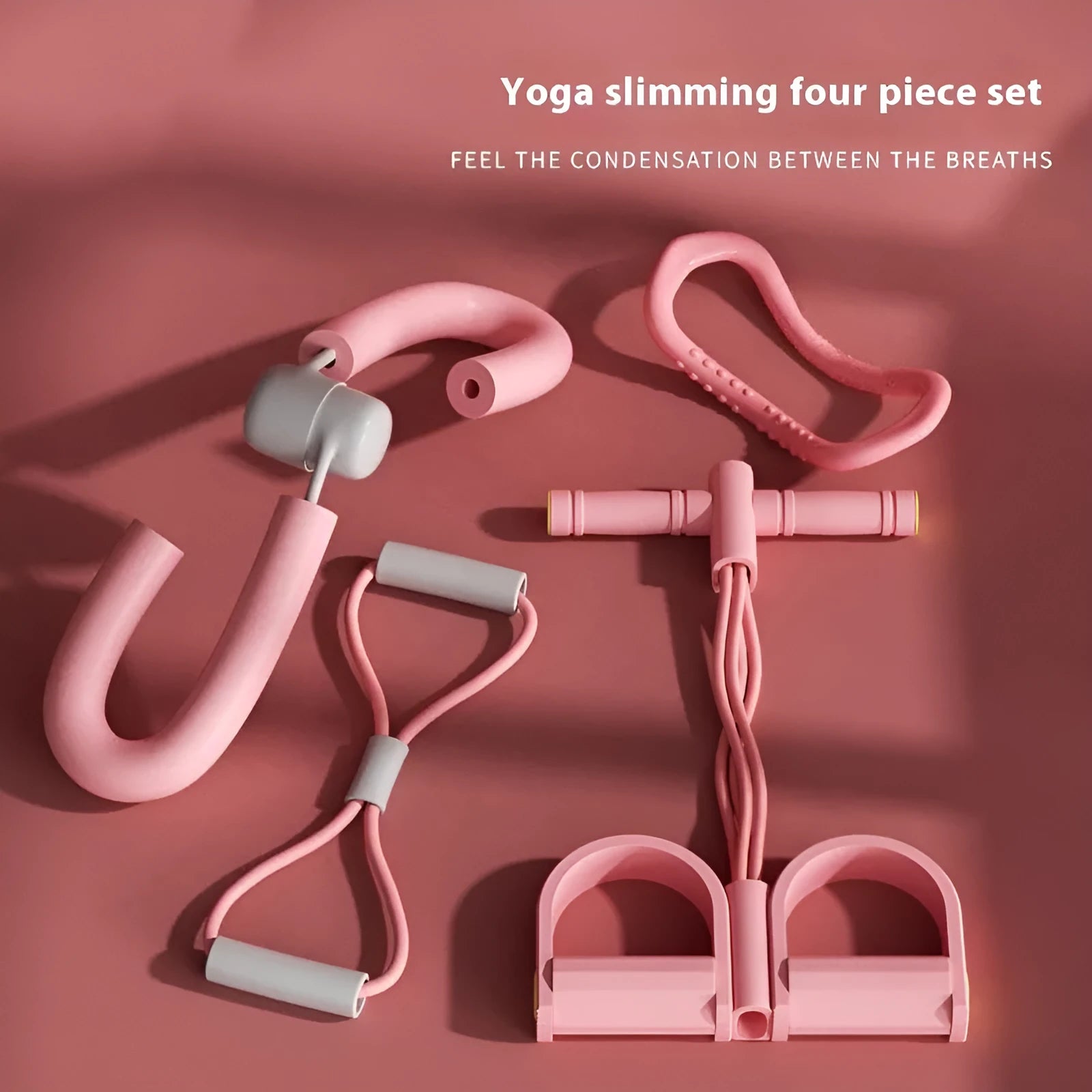 White yoga four piece set showing leg stretcher, yoga ring, pedal chest expander, and figure eight tension rope