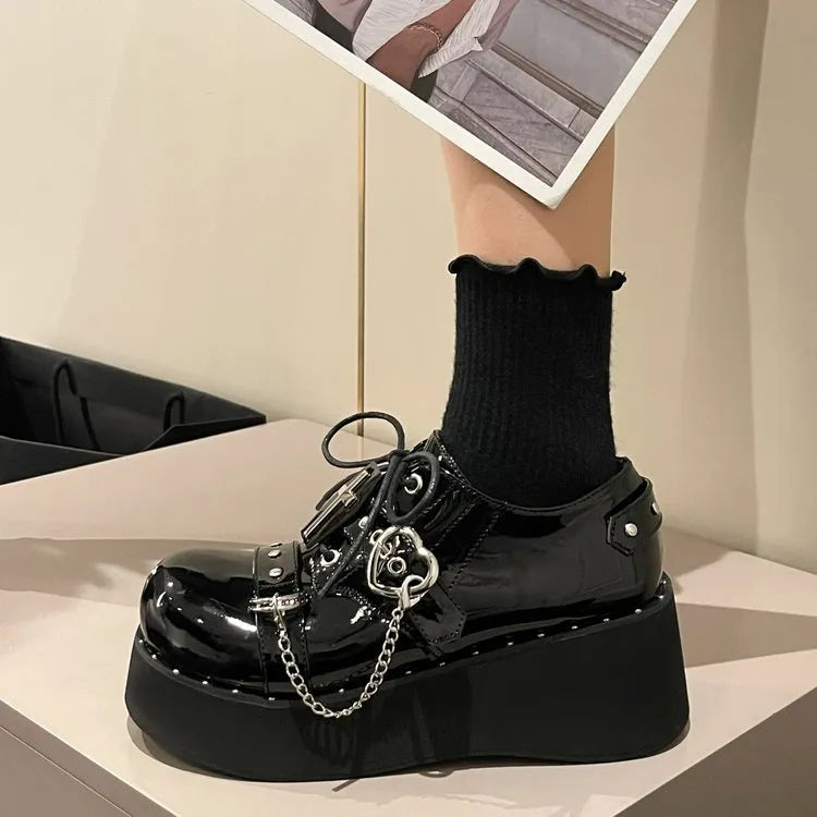 Solid black punk platform shoes with leather upper, rubber sole, and visible stitching detail