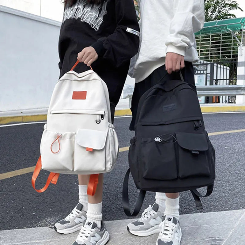Nylon backpack school bag for junior high students, large capacity 20-35L, waterproof, with computer pocket, available in black.