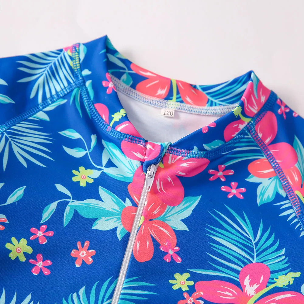 Girl's long sleeve one piece swimsuit in a briefs style on a hanger.