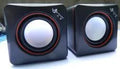 Black, small square USB-powered 2.0 computer speaker for desktop use.