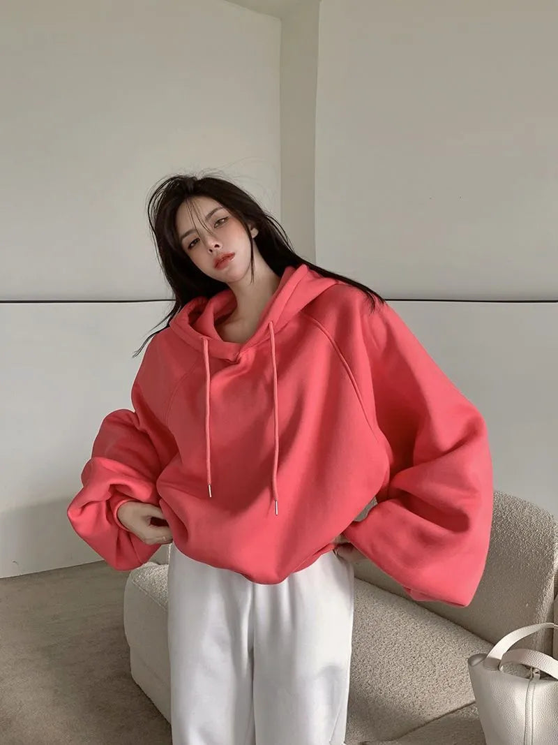 Watermelon red mulberry silk hooded sweater on a hanger, showing loose sleeveless fit.