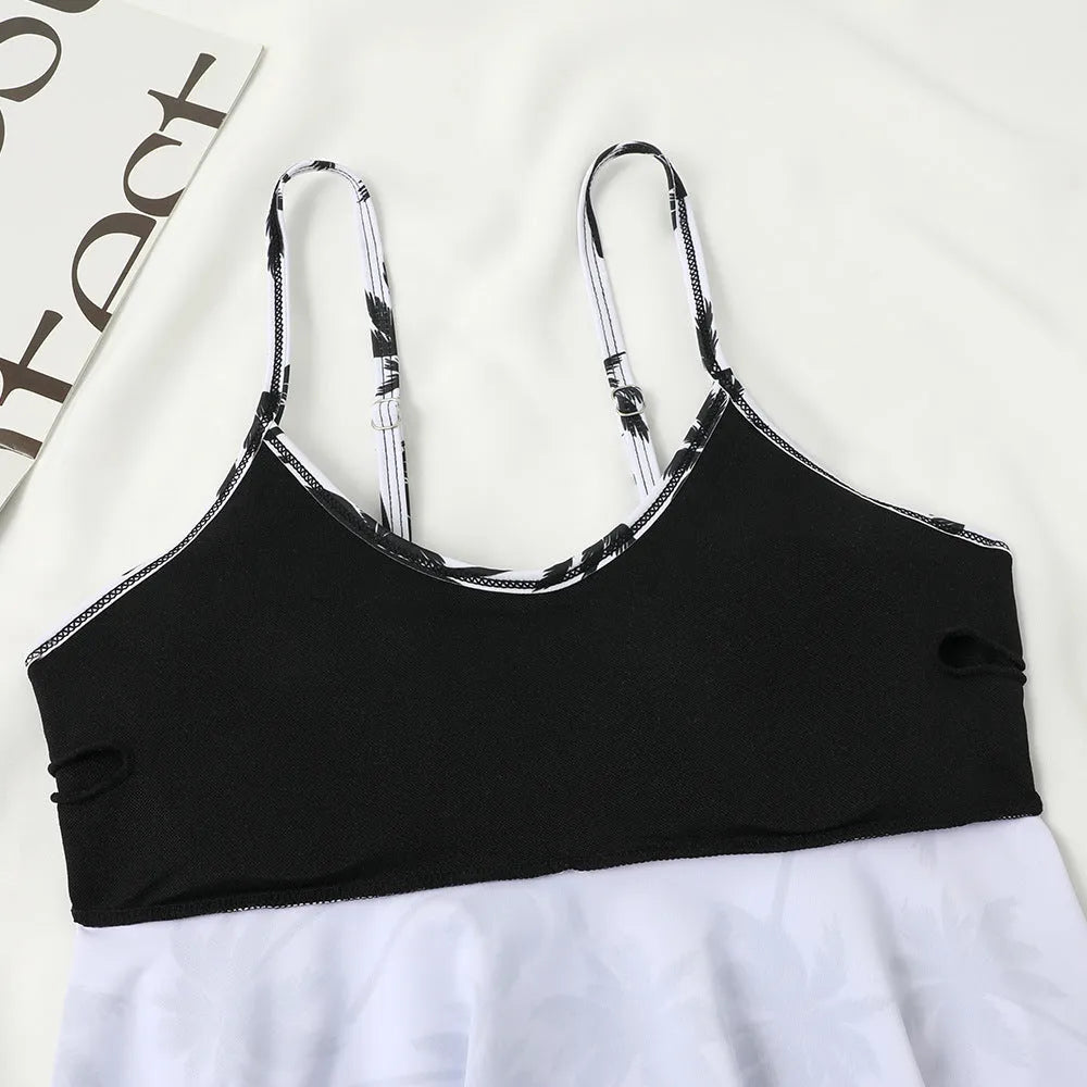 Black high waist swimsuit briefs with coconut tree print and sleeveless top on a mannequin
