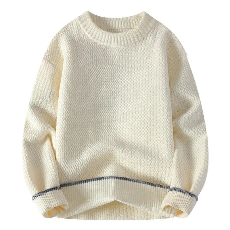 Man wearing a grey loose-fit round neck long sleeve pullover sweater.