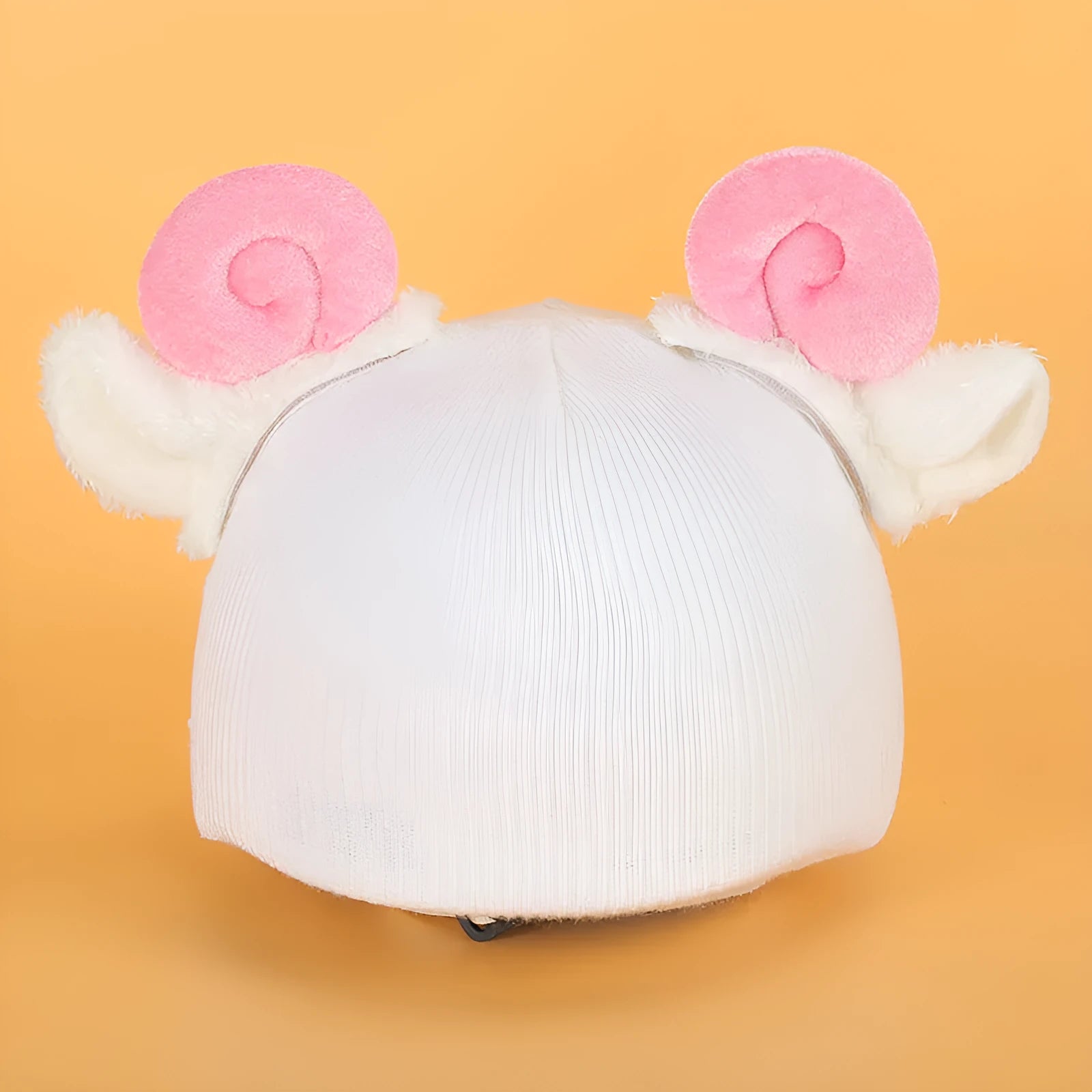 Soft plush cartoon character cover stretched over a pair of black on-ear headphones.