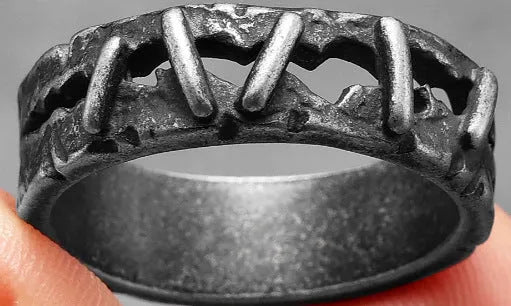 Close-up of a stainless steel double ring with dark punk stitching style detail.