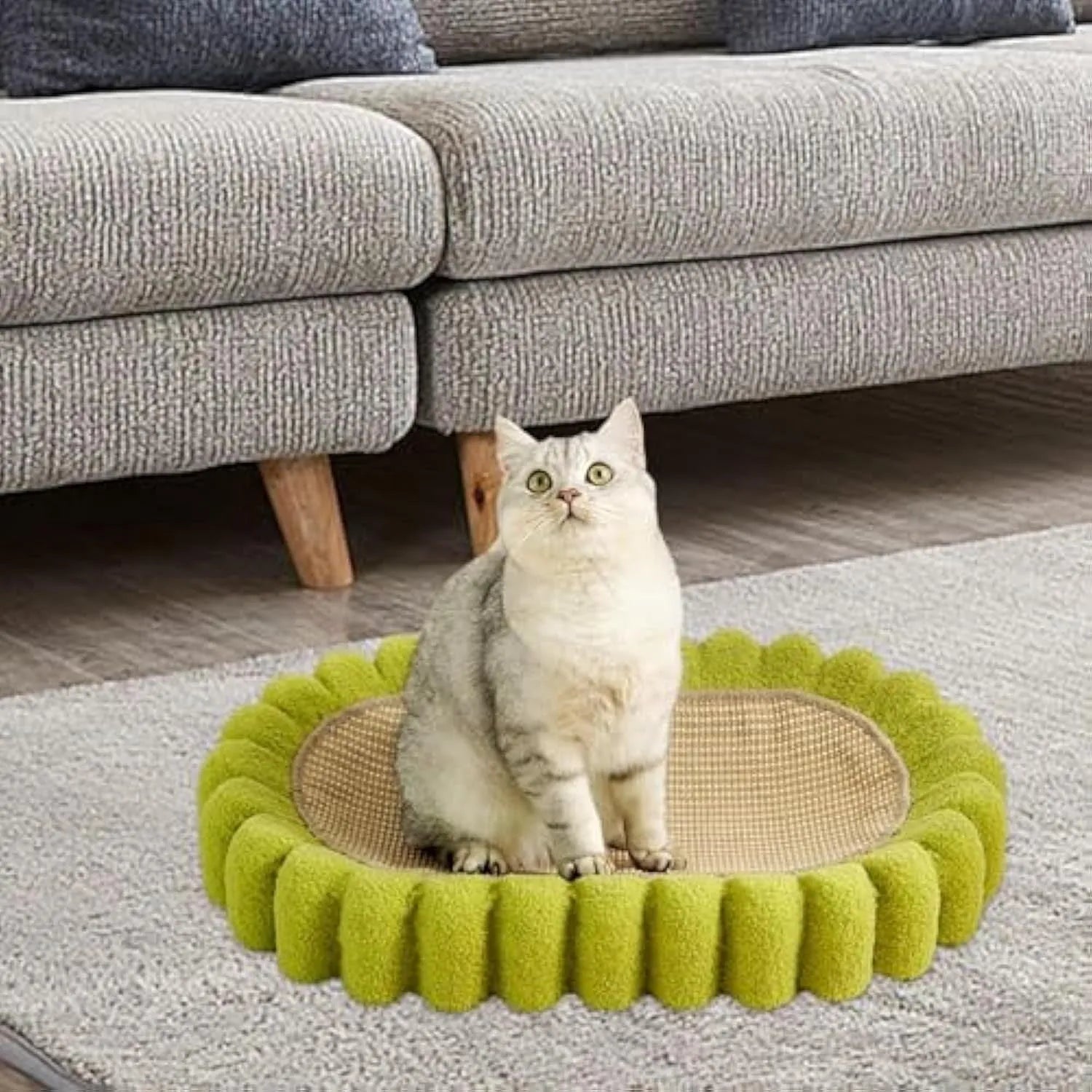 Green oval cat scratching pad and bed made from sisal fibre.